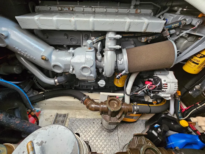 Slide: The Image of Engine compartment of a 1996 Tiara Yachts 3100 EXPRESS, showcasing mechanical components and wiring. - 25
