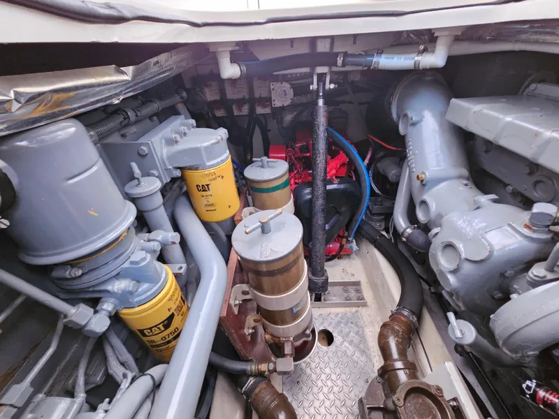 Slide: The Image of Engine room of 1996 Tiara Yachts 3100 EXPRESS with visible components and filters. - 26