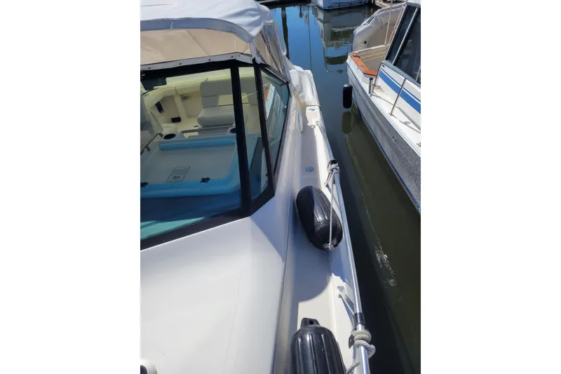 Slide: The Image of 1996 Tiara Yachts 3100 Open docked, showcasing sleek design and spacious interior. - 3