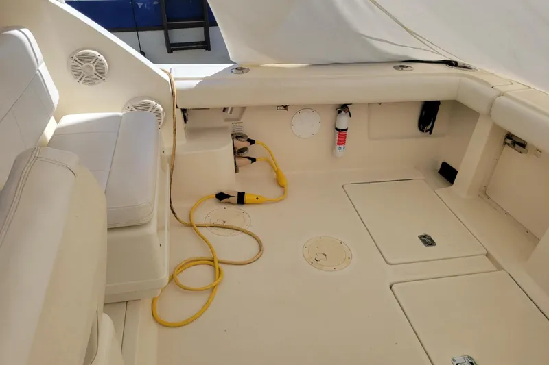 Slide: The Image of 1996 Tiara Yachts 3100 Open interior with seating, storage, and safety equipment. - 31