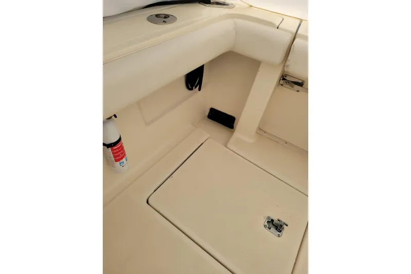Slide: The Image of 1996 Tiara Yachts 3100 Open interior detail with storage compartment and fire extinguisher. - 32