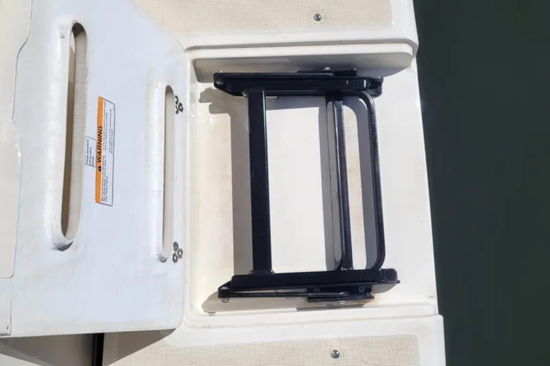 Slide: The Image of 1996 Tiara Yachts 3100 Open swim platform with foldable ladder and warning label. - 35