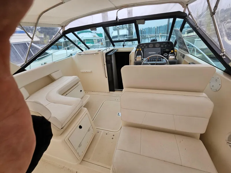 Slide: The Image of 1996 Tiara Yachts 3100 EXPRESS interior with beige seating and helm. - 4
