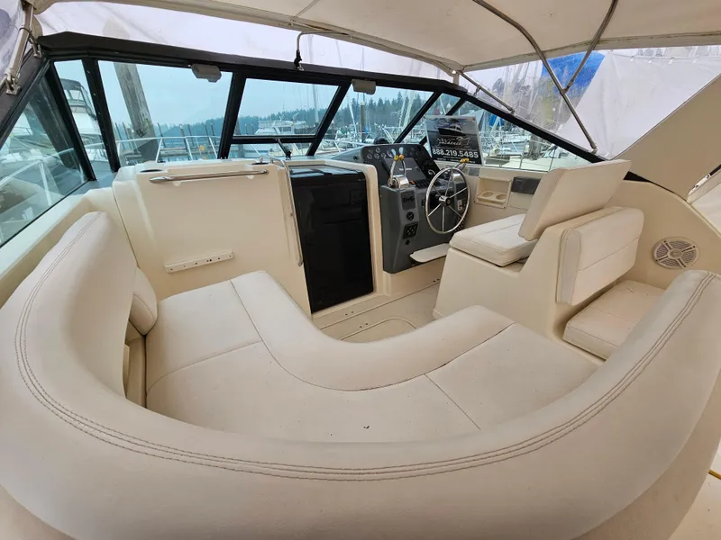 Slide: The Image of 1996 Tiara Yachts 3100 EXPRESS interior with helm and seating area. - 5