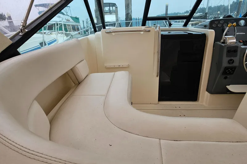 Slide: The Image of Interior of 1996 Tiara Yachts 3100 EXPRESS with beige seating and helm. - 6