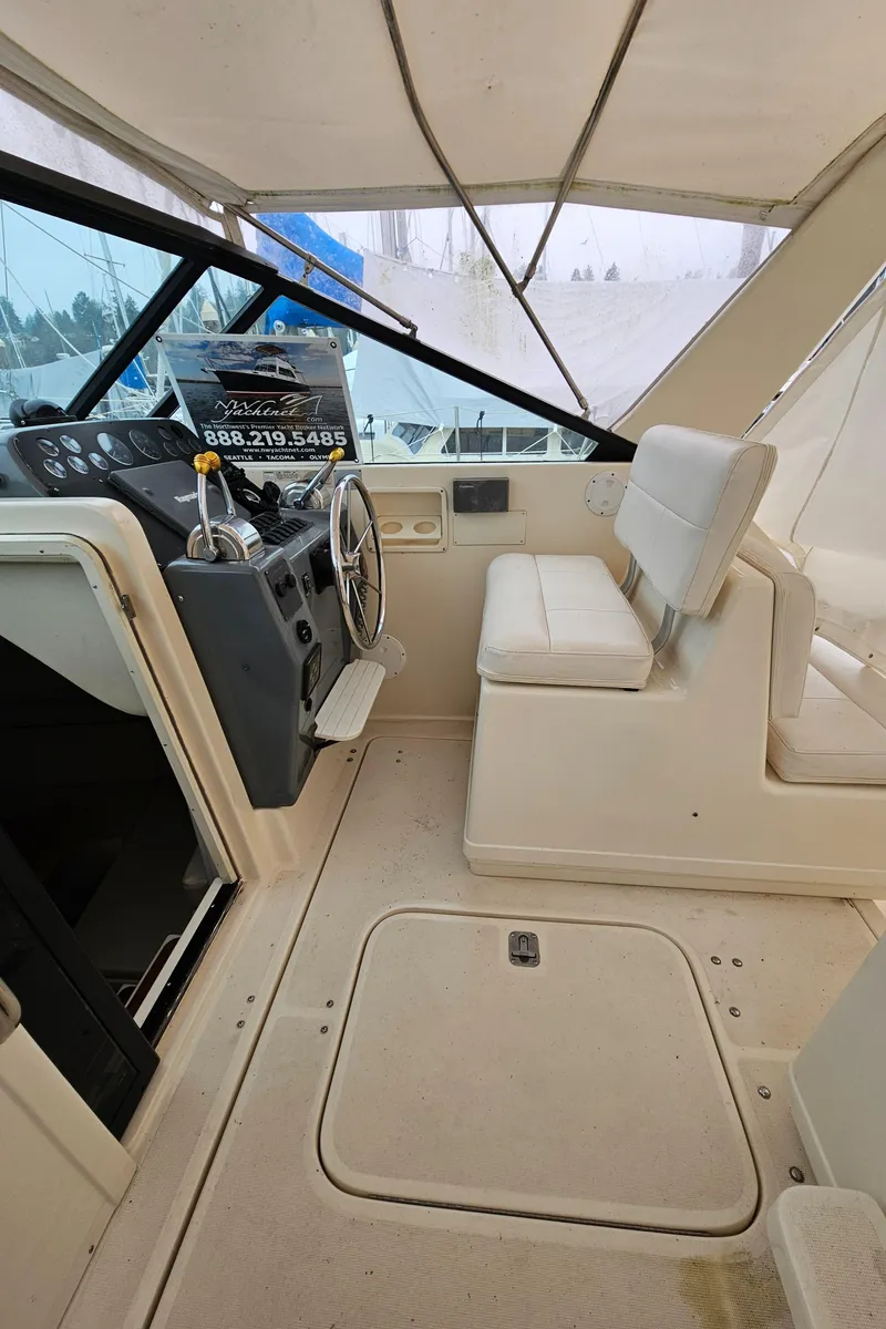Slide: The Image of 1996 Tiara Yachts 3100 EXPRESS helm with seating and steering wheel. - 9