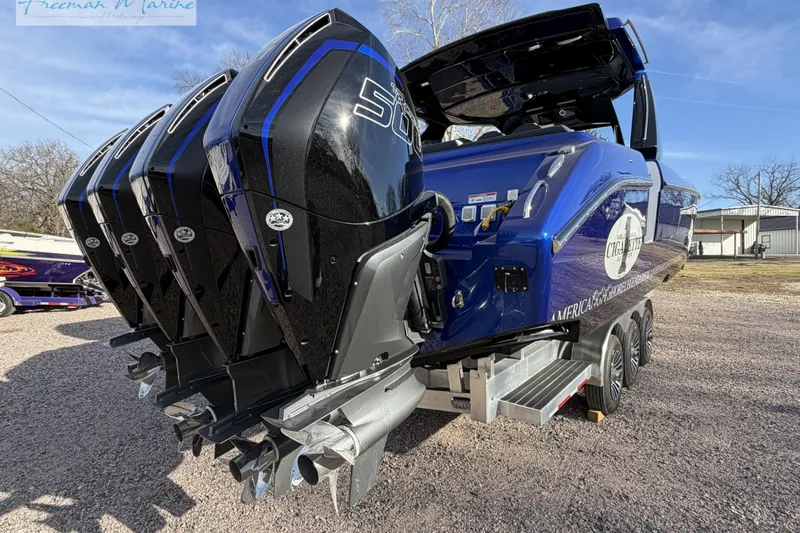 Slide: The Image of 2024 Cigarette 41' Nighthawk boat with powerful outboard engines, parked on a trailer. - 11