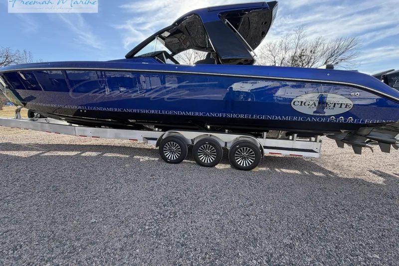 Slide: The Image of 2024 Cigarette 41' Nighthawk boat on trailer, blue exterior, parked outdoors. - 16