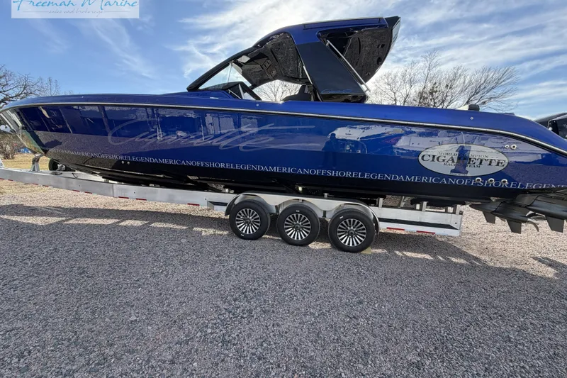 Slide: The Image of 2024 Cigarette 41' Nighthawk boat on trailer, blue exterior, side view. - 17