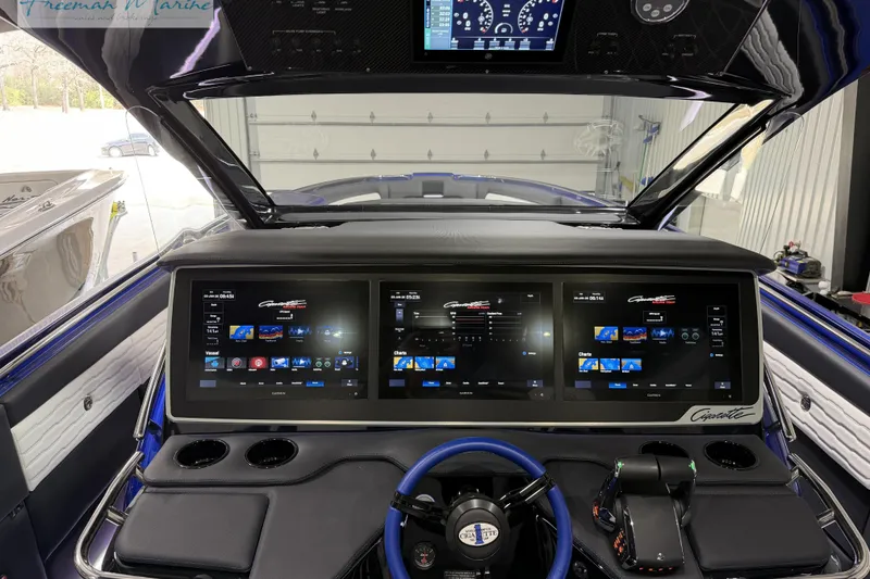 Slide: The Image of 2024 Cigarette 41' Nighthawk dashboard with advanced digital displays and controls. - 2