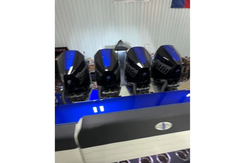 Slide: The Image of 2024 Cigarette 41' Nighthawk with four powerful outboard engines in a garage setting. - 25