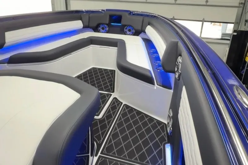 Slide: The Image of 2024 Cigarette 41' Nighthawk boat interior with sleek seating and blue LED lighting. - 27