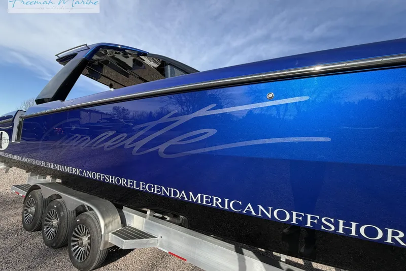 Slide: The Image of 2024 Cigarette 41' Nighthawk boat in vibrant blue on a trailer, side view. - 8