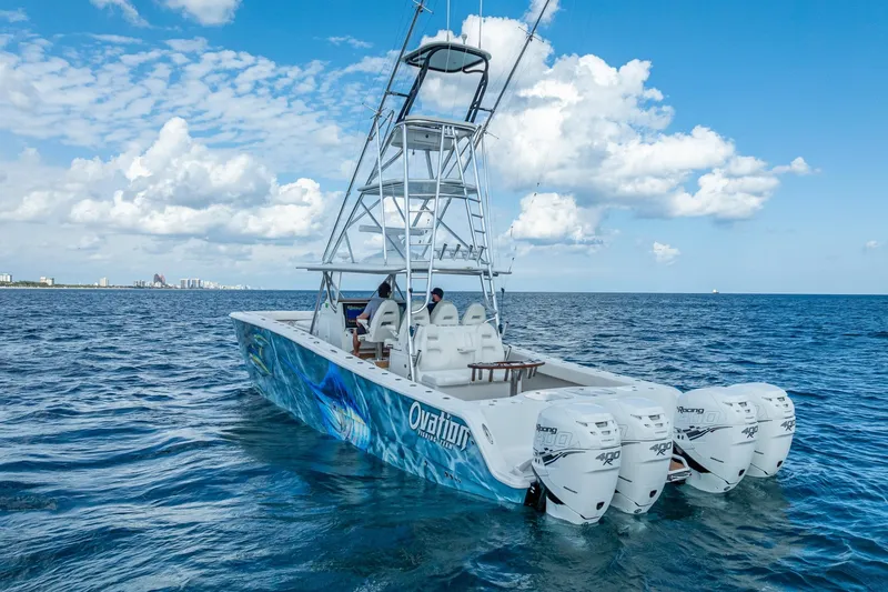 Slide: The Image of Luxurious waterfront property with 2019 Freeman 42LR boat docked, surrounded by palm trees. - 1