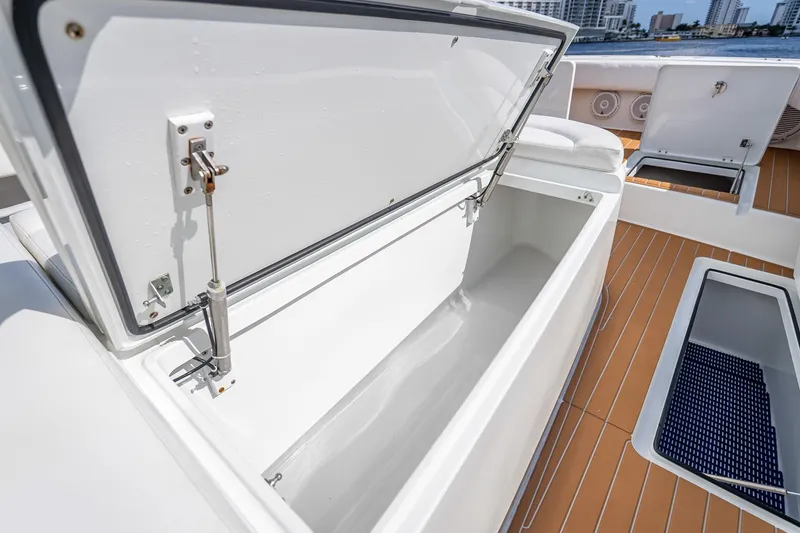Slide: The Image of 2019 Freeman 42LR boat deck with luxurious seating, overlooking a scenic waterfront cityscape. - 16