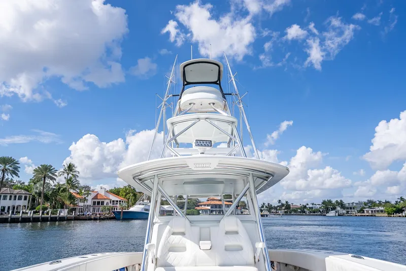 Slide: The Image of 2019 Freeman 42LR boat deck with open storage compartments, docked by waterfront buildings. - 20