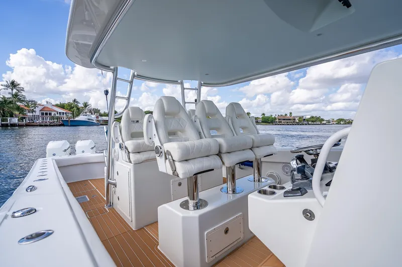Slide: The Image of 2019 Freeman 42LR boat with spacious deck and storage, cruising on calm waters. - 21