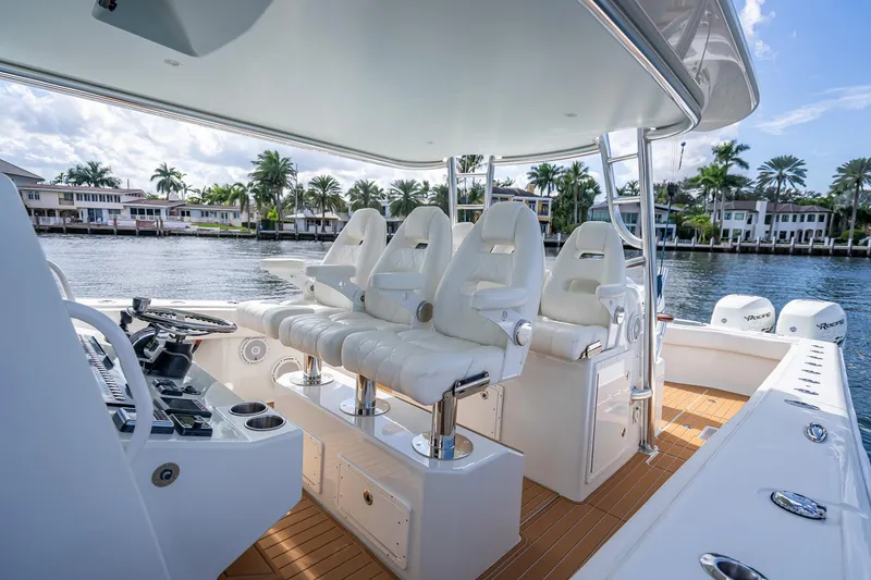 Slide: The Image of 2019 Freeman 42LR boat on water, clear sky, luxurious deck, waterfront homes in background. - 22