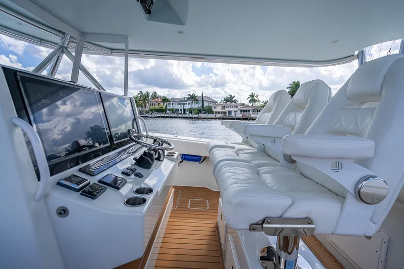 Slide: The Image of 2019 Freeman 42LR boat on a sunny day, with waterfront homes and palm trees in the background. - 23