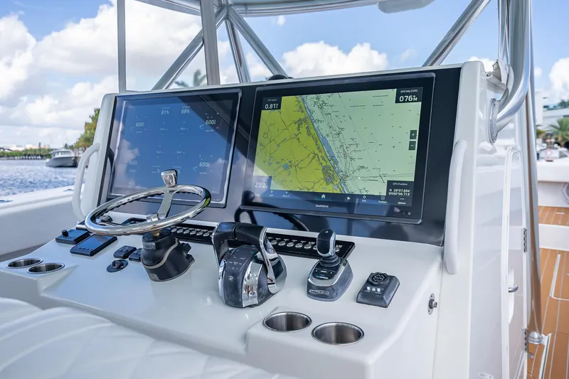 Slide: The Image of 2019 Freeman 42LR boat interior with modern dashboard and waterfront view. - 27