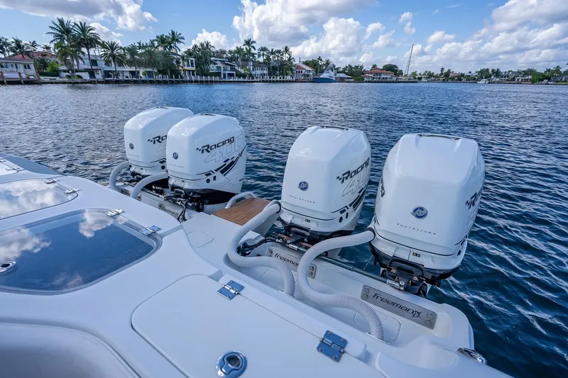 Slide: The Image of Luxury Freeman 42LR boat interior with fishing rod holders, docked by waterfront homes, 2019 model. - 36