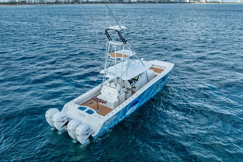 Slide: The Image of 2019 Freeman 42LR boat with four engines cruising on open ocean under blue sky. - 4
