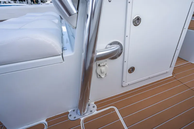 Slide: The Image of Open storage compartment on 2019 Freeman 42LR boat with cushioned seating. - 42