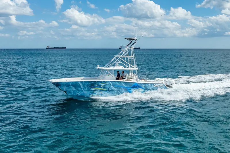 Slide: The Image of 2019 Freeman 42LR boat on open water, featuring four powerful outboard engines. - 7