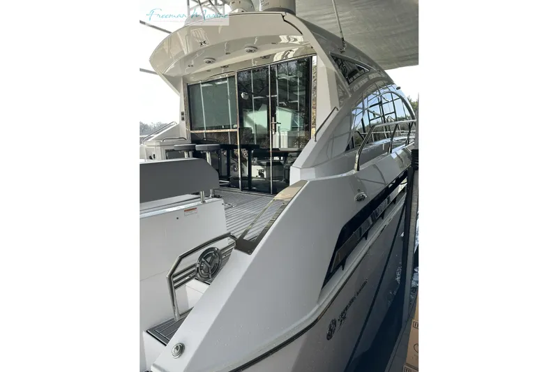 The Image of 2022 Cruisers Yachts 60 Cantius luxury yacht, sleek design, docked under cover. - 0