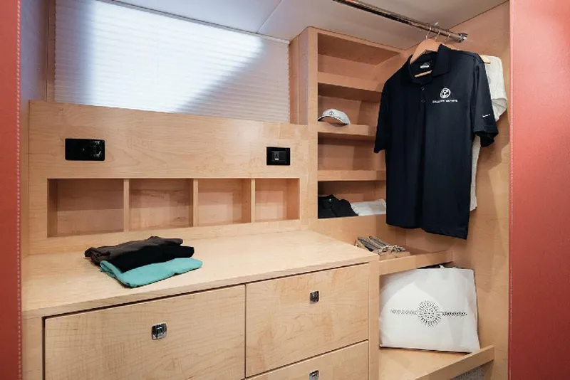 Slide: The Image of Manufacturer Provided Image: Modern wooden closet in 2022 Cruisers Yachts 60 Cantius with shelves, drawers, and hanging space. - 19