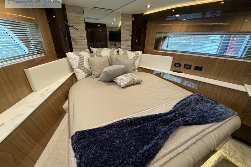 Slide: The Image of Luxurious 2022 Cruisers Yachts 60 Cantius bedroom with elegant bedding and modern design. - 25