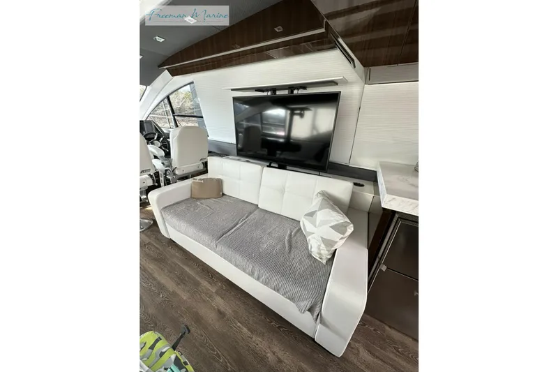 Slide: The Image of Luxurious interior of 2022 Cruisers Yachts 60 Cantius with modern sofa and TV setup. - 31