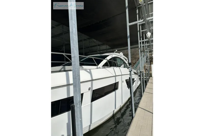 Slide: The Image of 2022 Cruisers Yachts 60 Cantius docked in a covered marina. - 34
