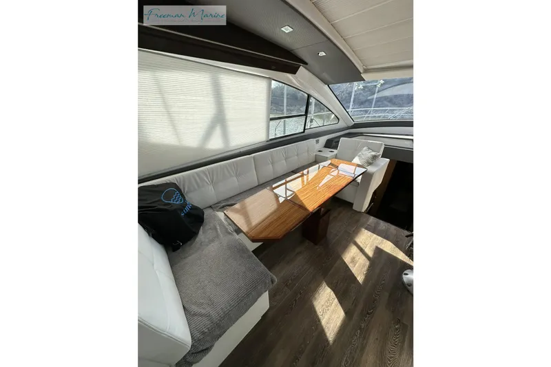 Slide: The Image of Luxurious interior of 2022 Cruisers Yachts 60 Cantius with elegant seating and wooden table. - 35