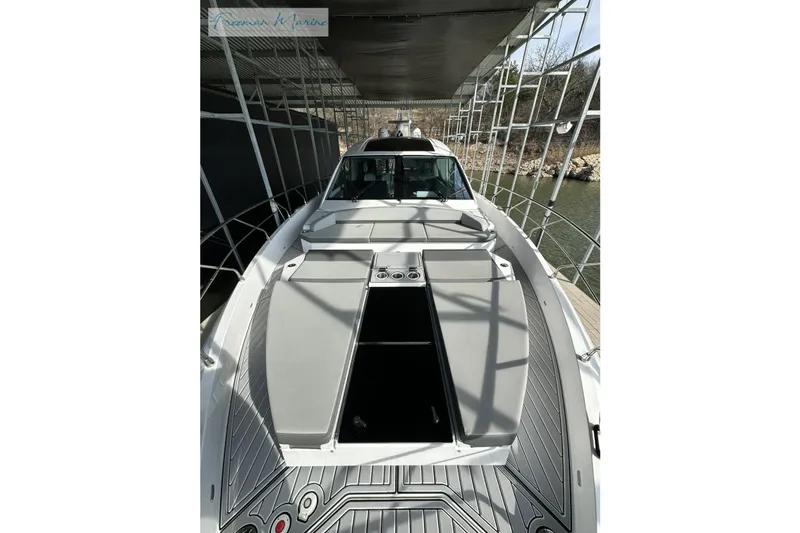 Slide: The Image of 2022 Cruisers Yachts 60 Cantius docked under a covered marina. - 36
