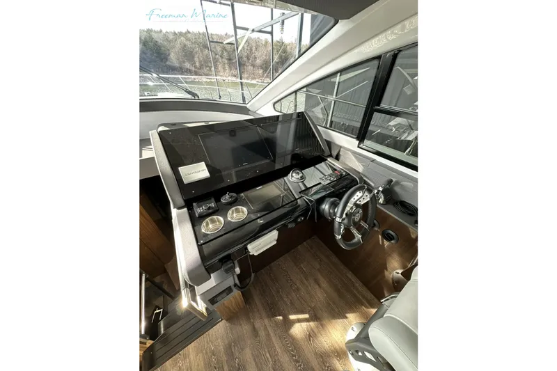 Slide: The Image of Helm station of 2022 Cruisers Yachts 60 Cantius with modern controls and navigation display. - 37