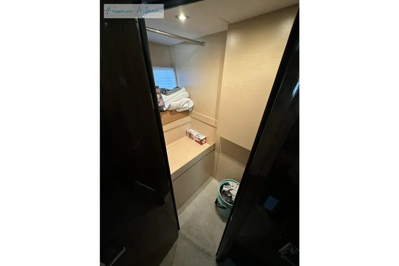Slide: The Image of Interior view of 2022 Cruisers Yachts 60 Cantius cabin with storage and laundry basket. - 43