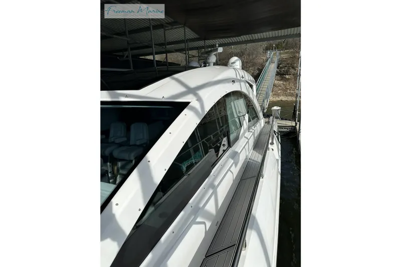 Slide: The Image of 2022 Cruisers Yachts 60 Cantius docked, showcasing sleek design and modern features. - 52
