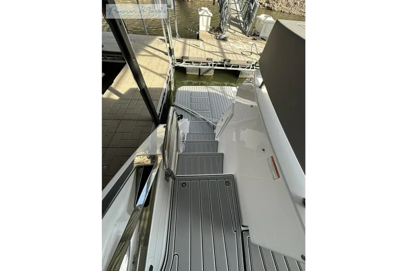 Slide: The Image of 2022 Cruisers Yachts 60 Cantius, docked with sleek deck and modern design. - 58