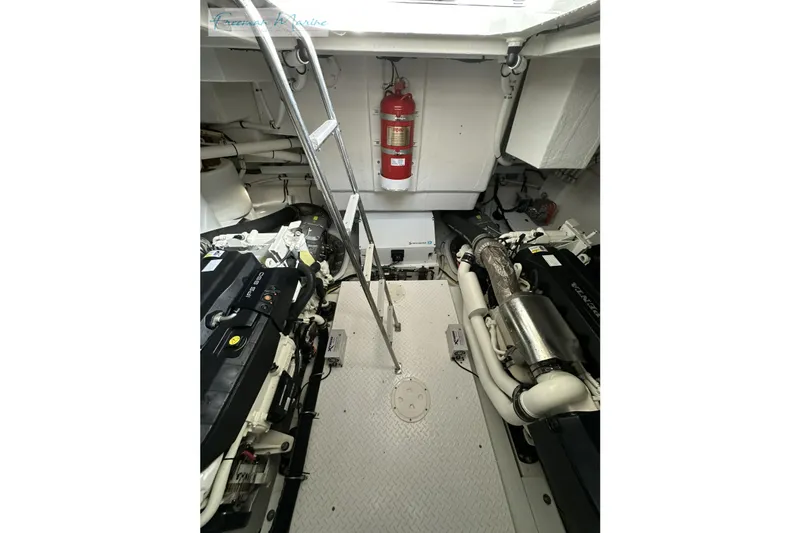 Slide: The Image of Engine room of 2022 Cruisers Yachts 60 Cantius with visible machinery and fire extinguisher. - 66