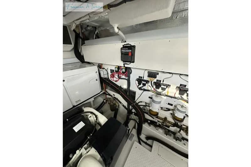 Slide: The Image of Engine room of 2022 Cruisers Yachts 60 Cantius, featuring electrical systems and components. - 68