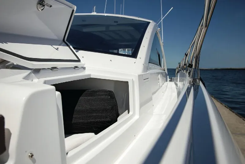 Slide: The Image of Manufacturer Provided Image: 2022 Cruisers Yachts 60 Cantius side view with open storage compartment. - 7