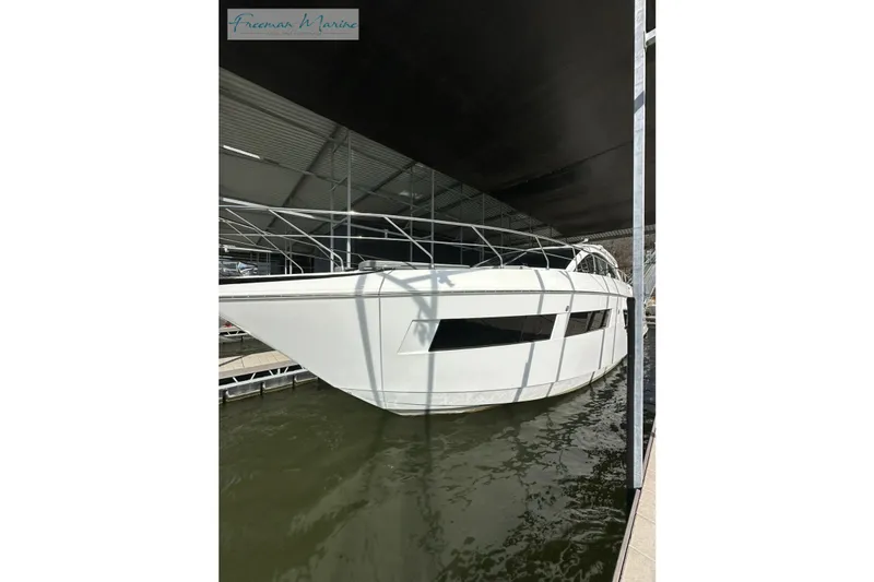 Slide: The Image of 2022 Cruisers Yachts 60 Cantius docked in a marina, side view. - 71