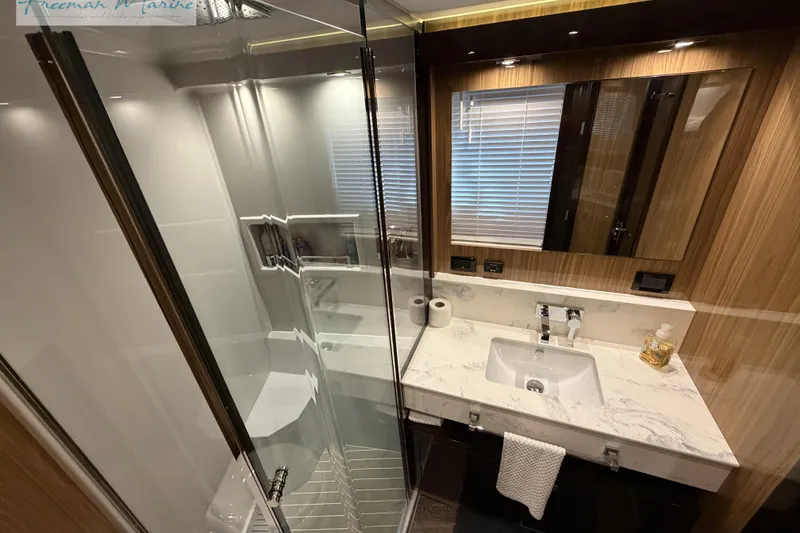 Slide: The Image of Luxurious bathroom in 2022 Cruisers Yachts 60 Cantius with marble sink and glass shower. - 74