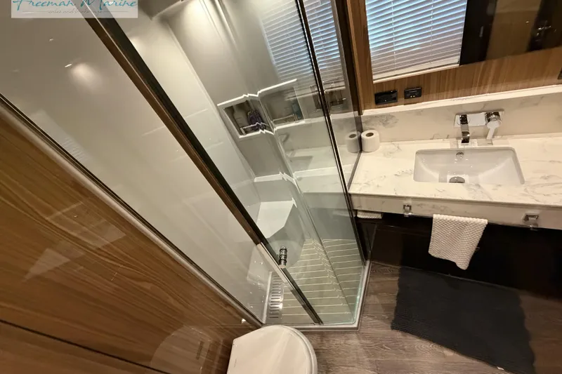 Slide: The Image of Luxurious bathroom in 2022 Cruisers Yachts 60 Cantius, featuring modern shower and marble sink. - 75