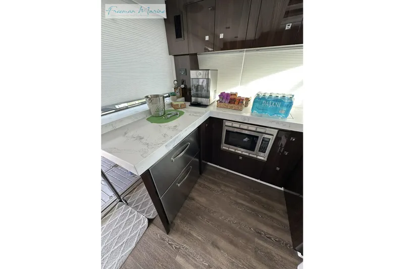 Slide: The Image of Modern kitchen in 2022 Cruisers Yachts 60 Cantius with sleek cabinetry and appliances. - 83