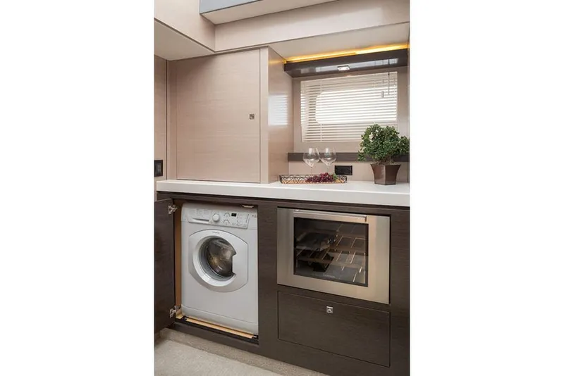 Slide: The Image of Manufacturer Provided Image: Modern laundry and wine storage area in 2022 Cruisers Yachts 60 Cantius. - 20