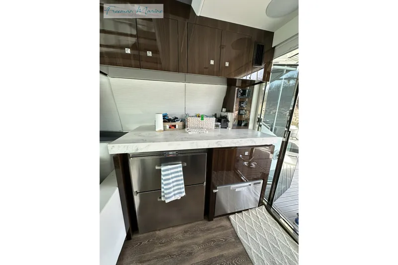 Slide: The Image of Modern kitchen area in 2022 Cruisers Yachts 60 Cantius with sleek cabinetry and appliances. - 27