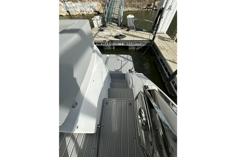 Slide: The Image of 2022 Cruisers Yachts 60 Cantius docked, showcasing sleek deck and modern design. - 59