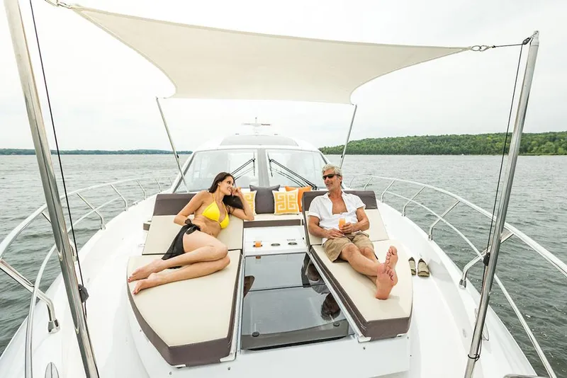 Slide: The Image of Manufacturer Provided Image: Couple relaxing on the deck of a 2022 Cruisers Yachts 60 Cantius. - 6